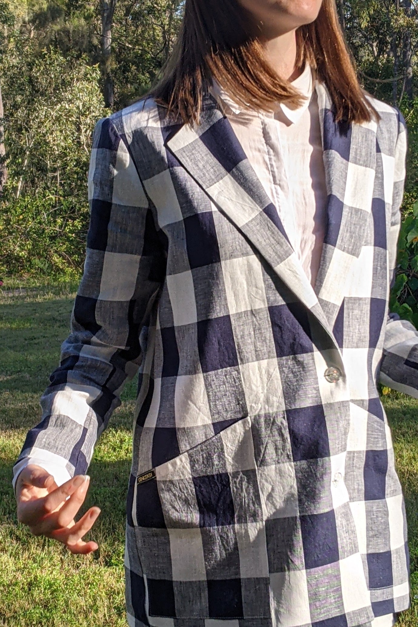 Krissy wears a Two Spirits Genderless Hoodie in rich Burgandy with the black Two Spirits print on the front and arms.