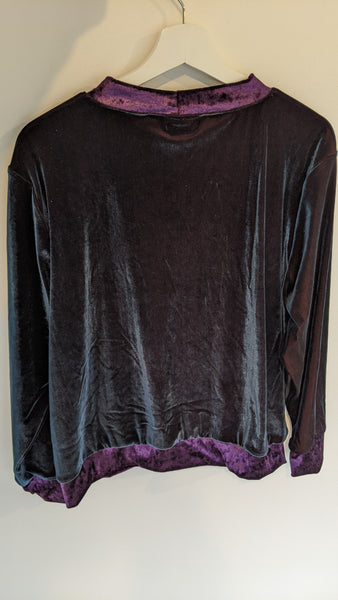 This is the back view of the Velvet Tidal Jumper in size XL, hanging on a hanger. The Velvet is almost black with a turquoise sheen, with Amythyst purple velvet hem, collar, and sleeve cuffs