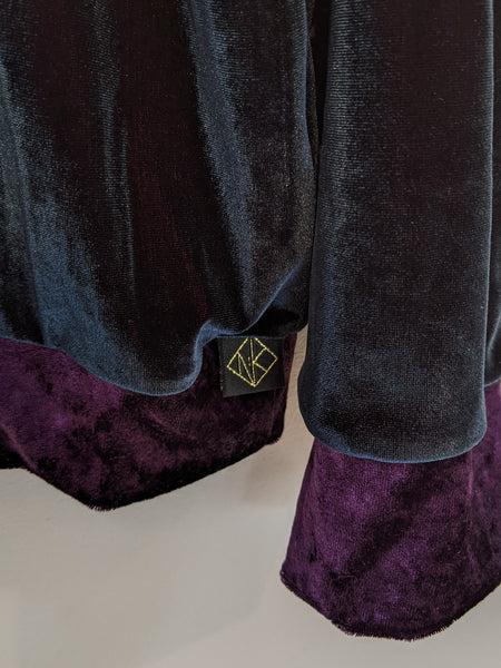 A close up of the hem logo tag which is black with gold embroidery to show the geometric Genkstasy logo. And a close up of the amethyst velvet cuff detail.
