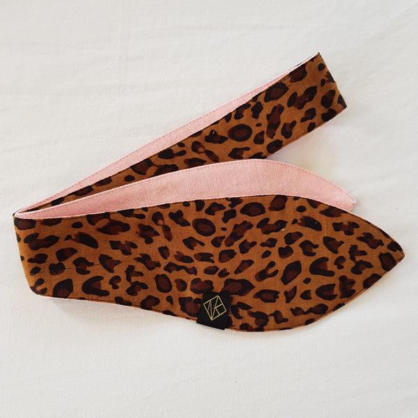 picture of bandanna with classy leopard print cotton on one side, and pink textured cotton on the other side.